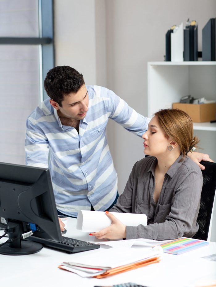front-view-young-beautiful-lady-grey-shirt-talking-discussing-something-with-young-man-inside-office-daytime-building-job-activity-min
