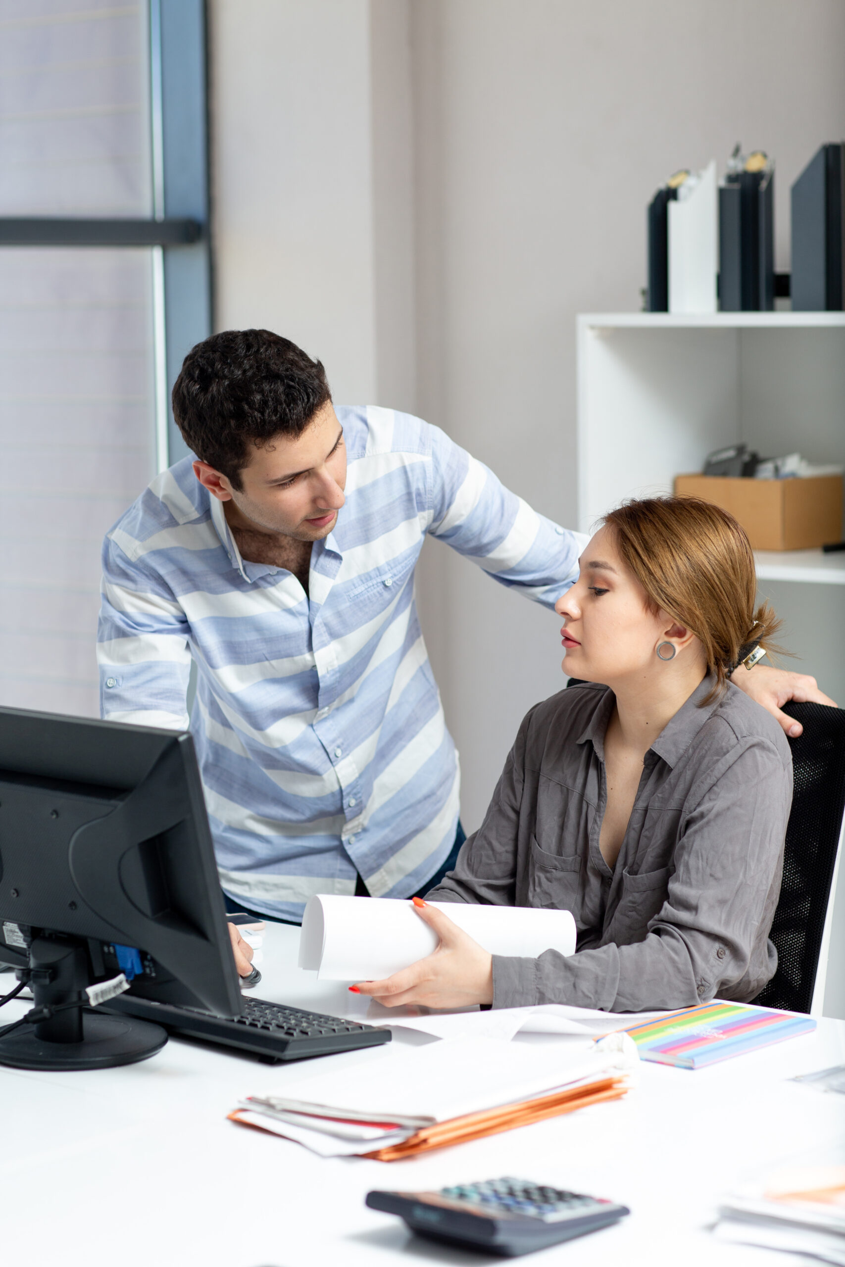 front-view-young-beautiful-lady-grey-shirt-talking-discussing-something-with-young-man-inside-office-daytime-building-job-activity-min